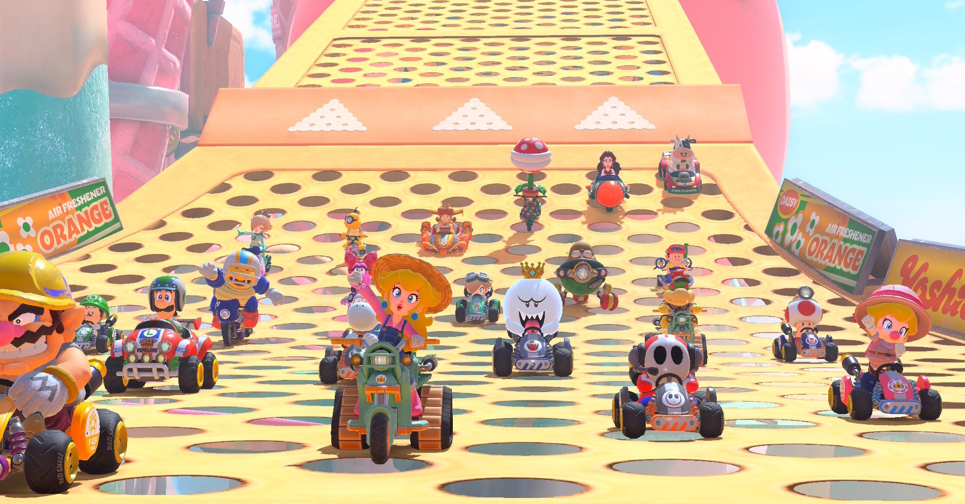 Um conjunto completo de 24 pilotos em Mario Kart World, com Peach e Wario na liderança