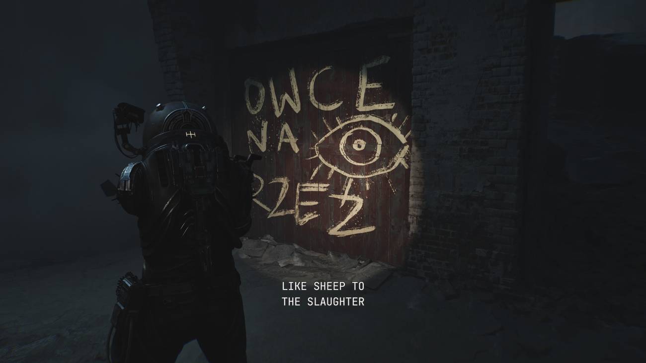 O viajante olha para graffiti que lê, "Como ovelhas para o massacre."