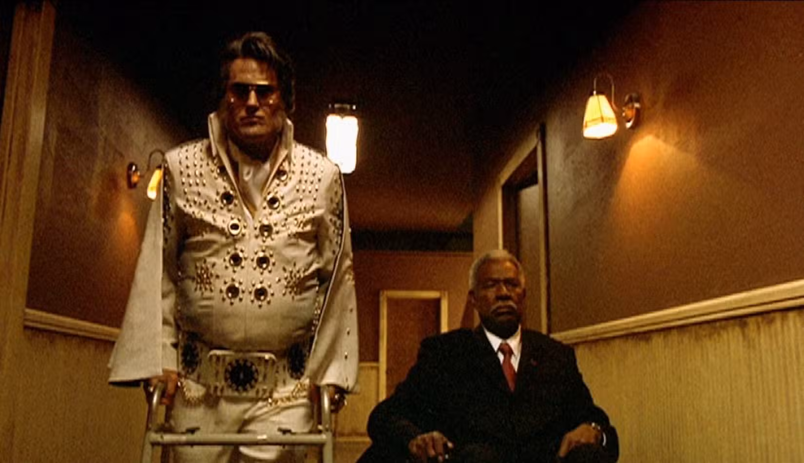 Bruce Campbell e Ossie Davis caminham pelo corredor de uma casa de repouso em Bubba Ho-Tep, onde interpretam personagens convencidos de que são Elvis e JFK, respectivamente.
