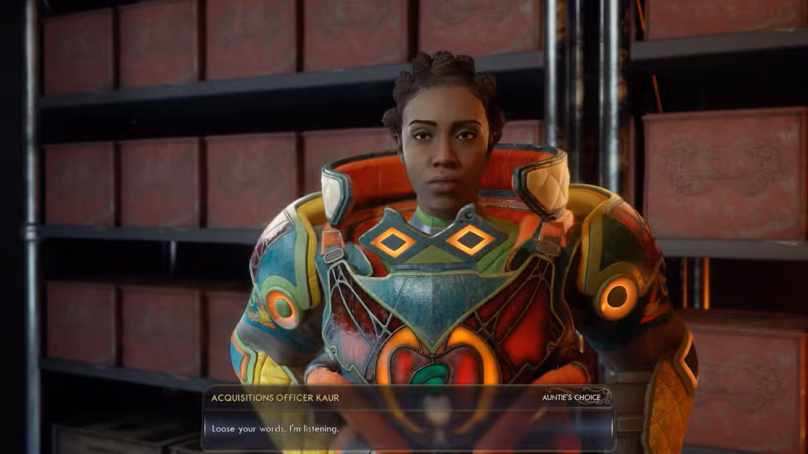 A oficial Kaur, uma mulher negra com armadura Spacer's Choice, olha para o jogador e diz: "Solte suas palavras. Estou ouvindo."