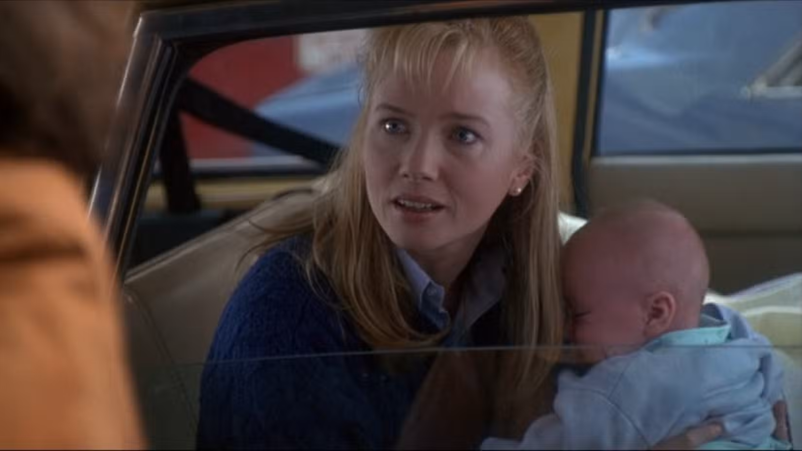 Rebecca De Mornay segura o bebê de seu chefe em uma cena do thriller de 1992, The Hand That Rocks the Cradle
