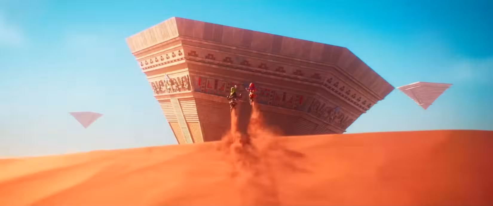Luigi e Mario lançam uma duna de areia em direção a uma pirâmide invertida do Reino de Areia no trailer do filme Super Mario Galaxy 