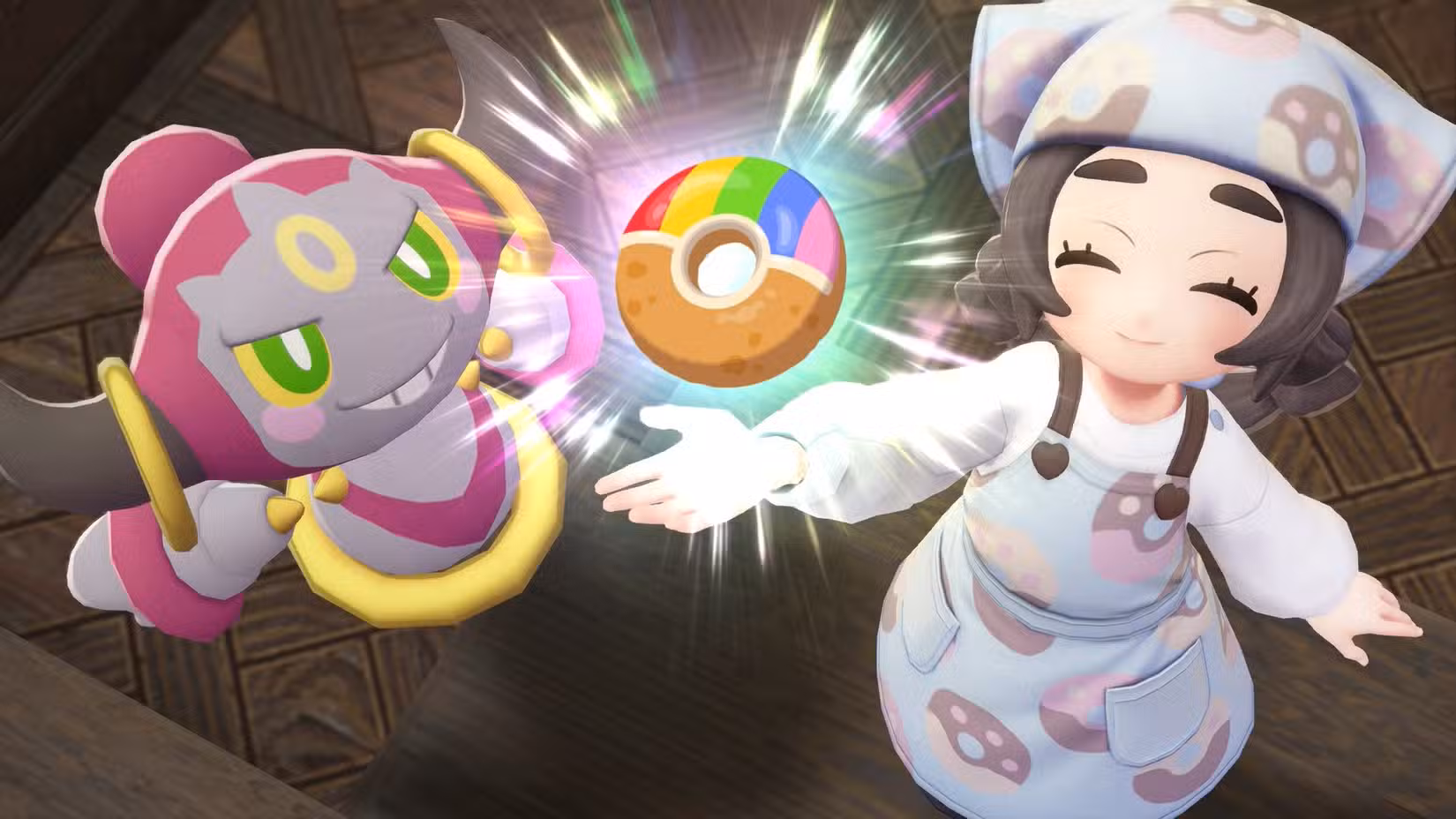Ansha e Hoopa levantam com entusiasmo um donut com cobertura de arco-íris em Pokémon Legends: ZA.