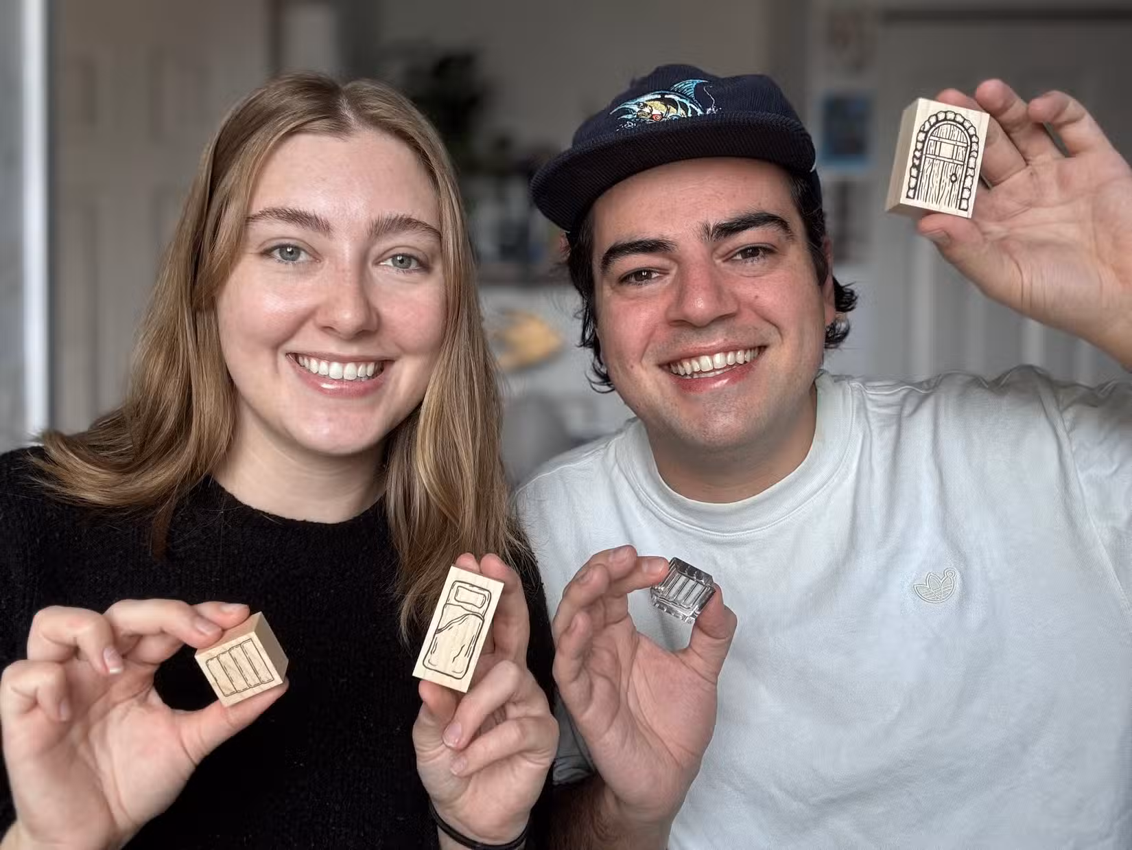 Karoline Moore e Jacob Harris segurando selos de mesa