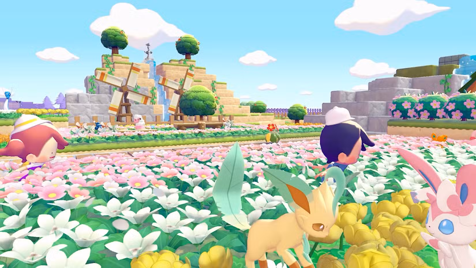Pokémon explora um campo de flores com moinhos de vento ao fundo em Pokémon Pokopia